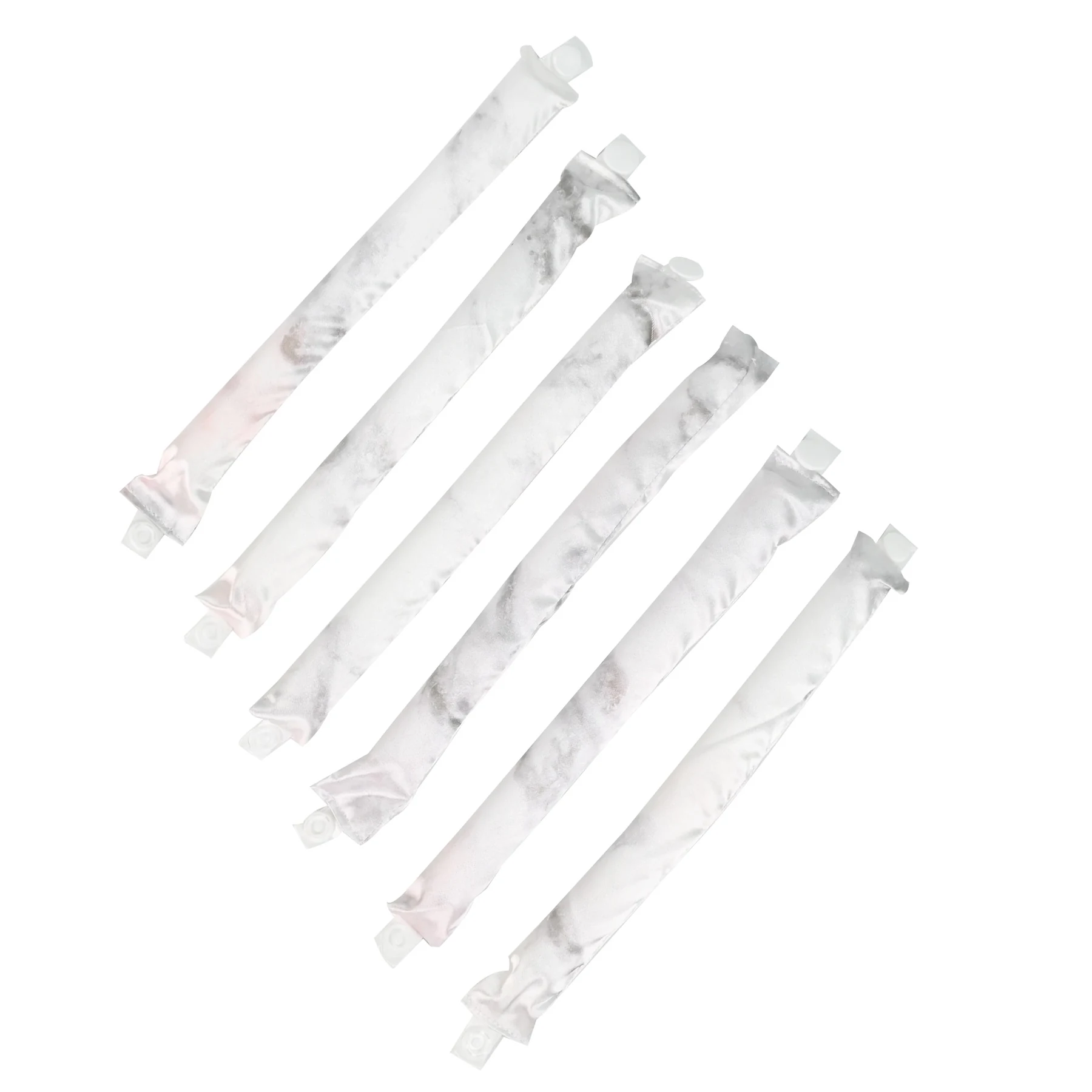 Set of foam core hair curl rollers wrapped in satin fabric laid out flat