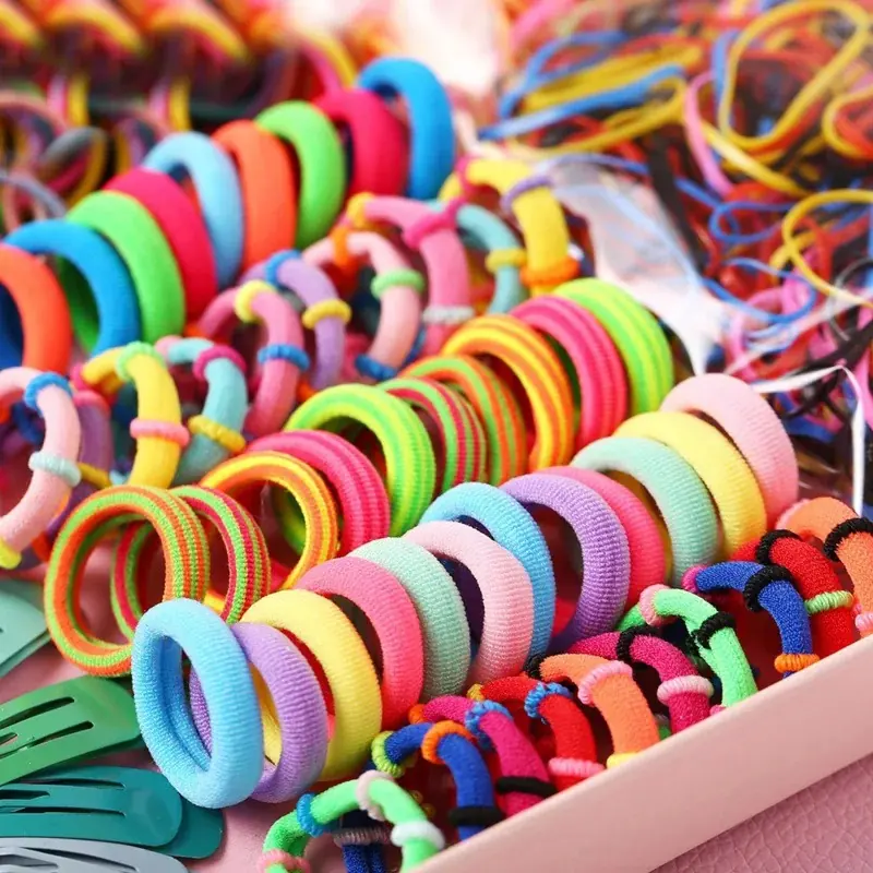 Set of mixed colour nylon hair ties laid out with different shapes and sizes