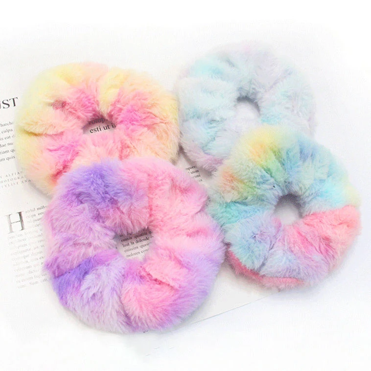 Set of pastel plush hair scrunchies laid out in a row
