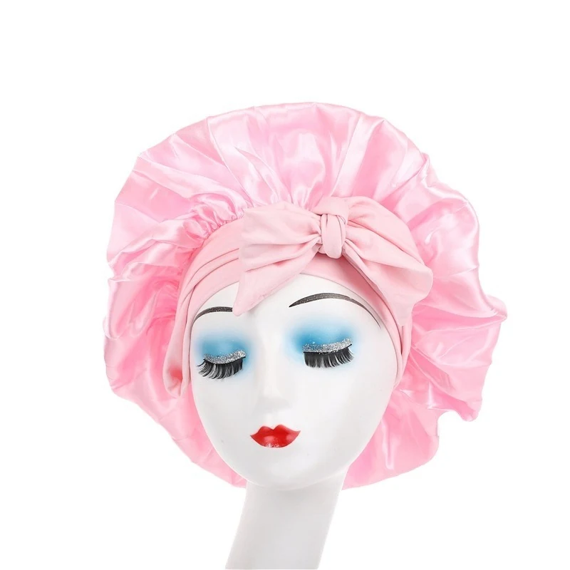 Satin bonnet laid flat showing the adjustable tie band and smooth fabric surface