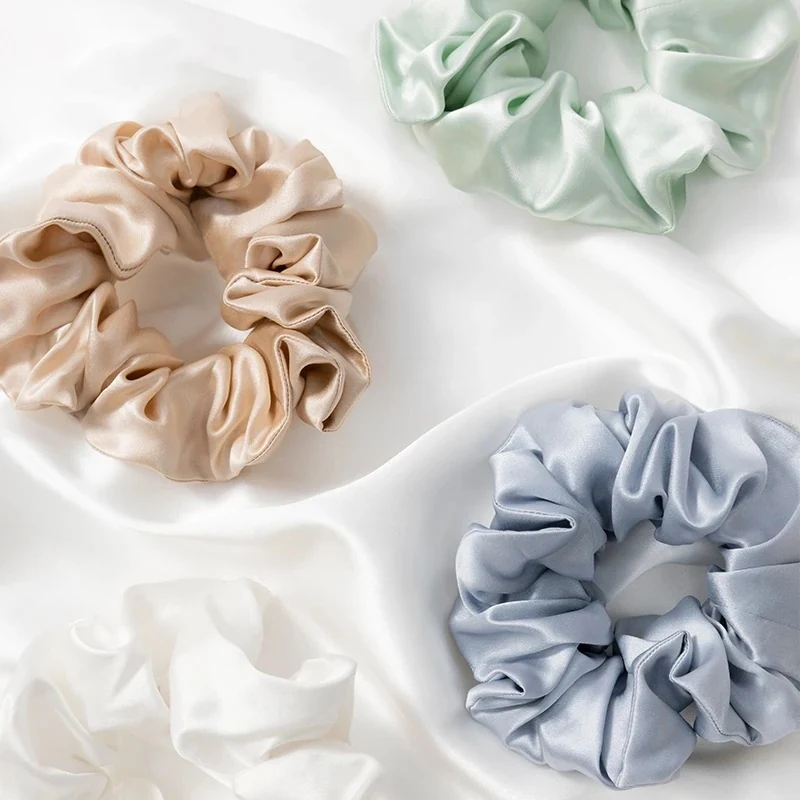Satin silk solid colour scrunchie laid flat showing the smooth fabric surface
