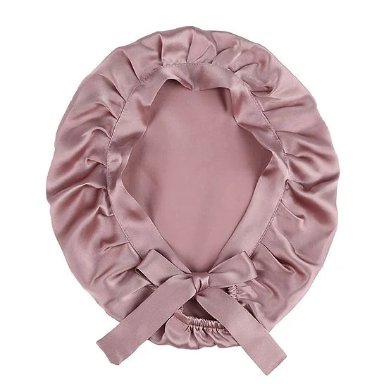 Silk hair bonnet with adjustable ribbons laid flat, showing double-layer construction