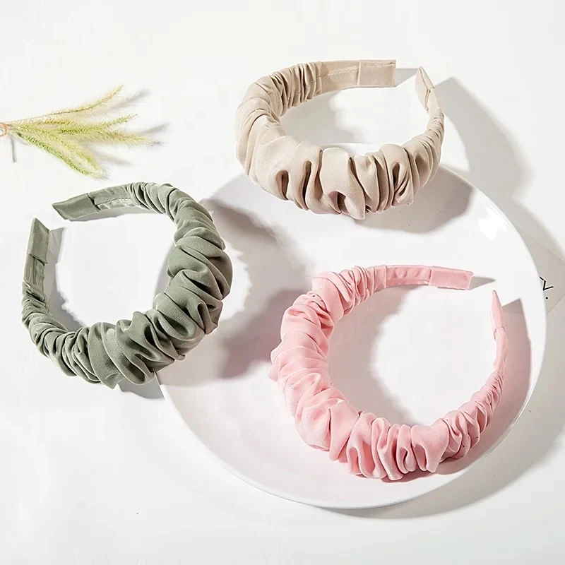 Solid colour headband made from custom fabric, laid flat showing the hand-stitched seam