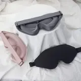 3D silk sleeping eye mask laid flat showing the cup-shaped design and reinforced stitching