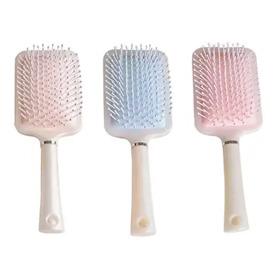 Air cushion comb in use on long curly hair, showing smooth glide