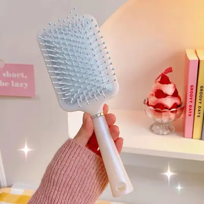 Air cushion comb packed in a custom polybag with brand label