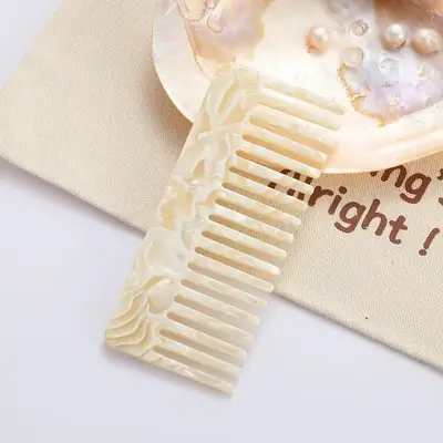 Comb displayed with a matching cushion brush and scrunchie in a gift box