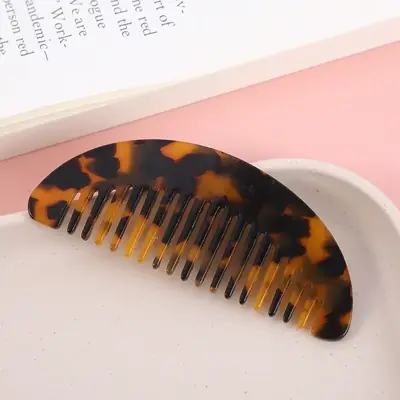 Hair comb being used on damp hair to detangle gently
