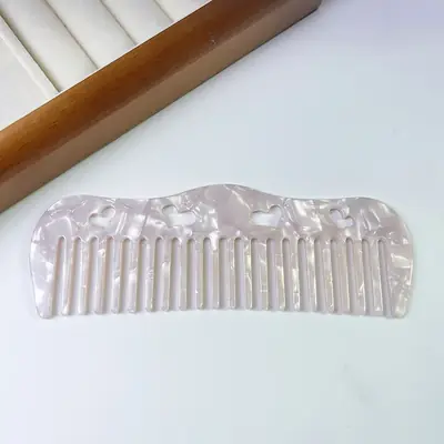 Comb displayed in a retail gift set with a satin bonnet and cushion brush