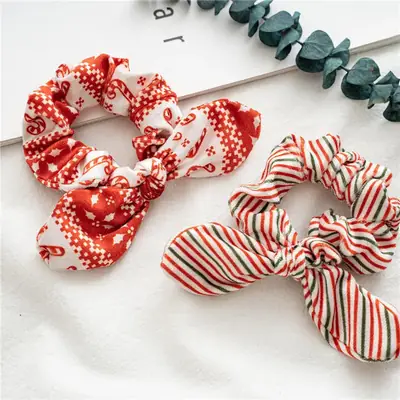 Rabbit ear hair scrunchie worn on a woman's hair showing the soft fabric and elastic core