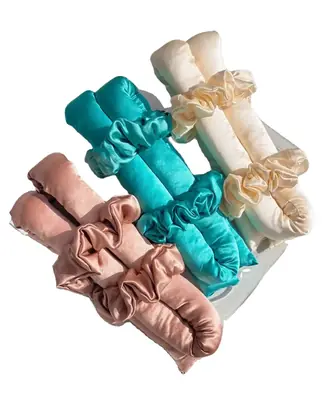 Satin hair roller wrapped in hair showing the pin-free hold with scrunchie