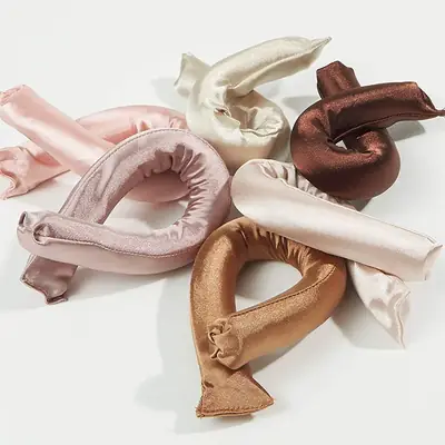 Satin heatless curler wrapped in hair showing the pin free hold
