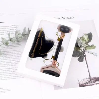 Jade roller and Gua Sha tool side by side with a facial serum bottle