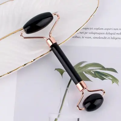 Gua Sha tool used on the jawline with facial oil applied