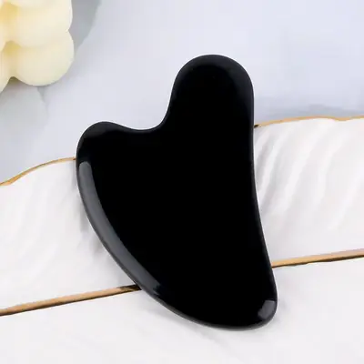 Close-up of the flat Gua Sha edge showing smooth hand-polished finish