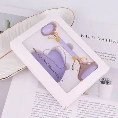 Violet-coloured jade tools displayed with a silk pillowcase and facial oil
