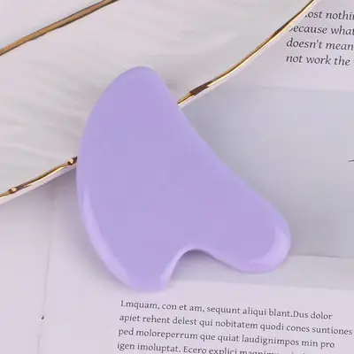 Jade roller rolling across the forehead in an upward motion