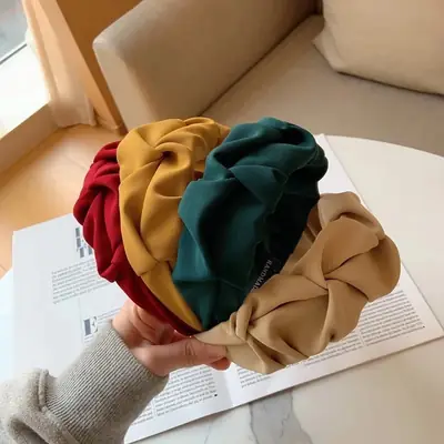 Headband worn on a model's head, showing the fit and fabric drape