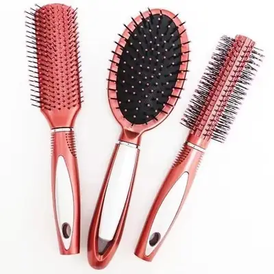 Hand holding the cushion comb with anti-slip handle, brushing through wet hair