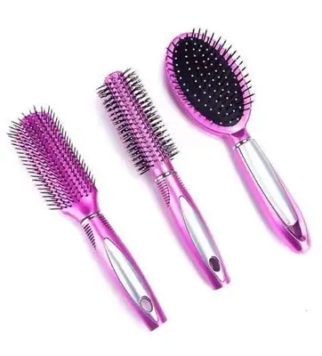 Close-up of the rounded nylon pins on a cushion comb, gliding over a strand of hair