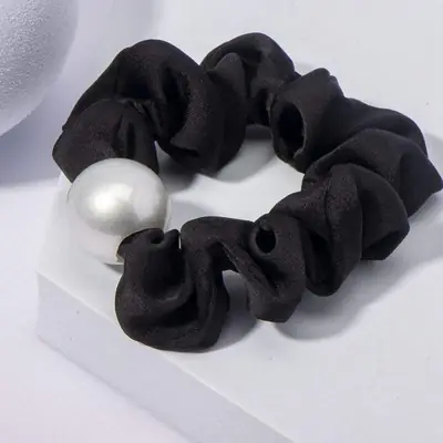 Close-up of the hand-stitched seam on the satin scrunchy