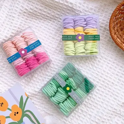 Close-up of a hand-stitched nylon hair tie showing the seam and elastic band