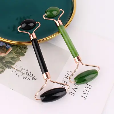 Side view of the dual-ended tool showing the transition from roller to Gua Sha