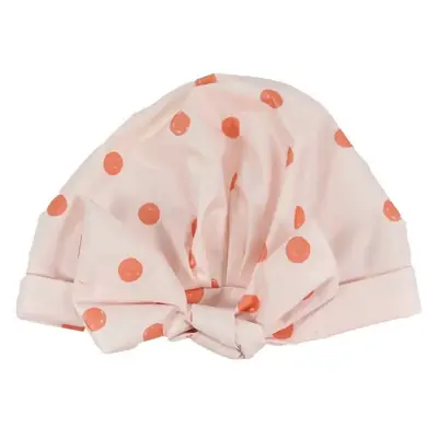 Shower cap displayed with matching bath gloves and loofah in a retail gift set