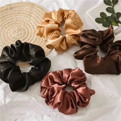 Close-up of the hand-stitched seam on a silk scrunchie