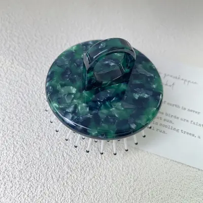 Comb used on hair to demonstrate gentle detangling and scalp massage
