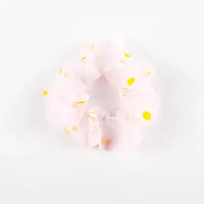 Pink organza scrunchie wrapped around a section of hair showing the rubber core