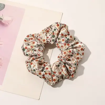 Hair scrunchie wrapped around a ponytail showing the gentle hold