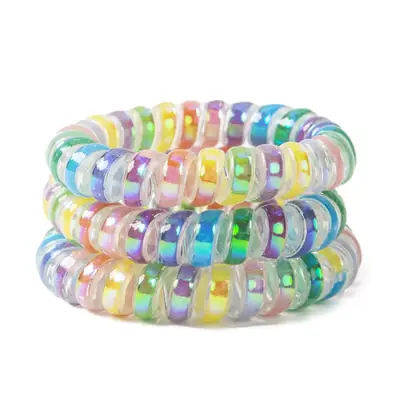 Multiple spiral hair ties in different custom colours laid out for comparison