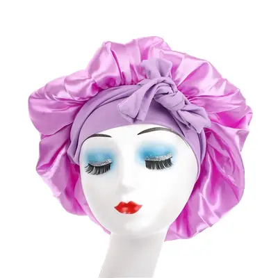 Satin bonnet placed on a pillow with hair covered, demonstrating sleep use