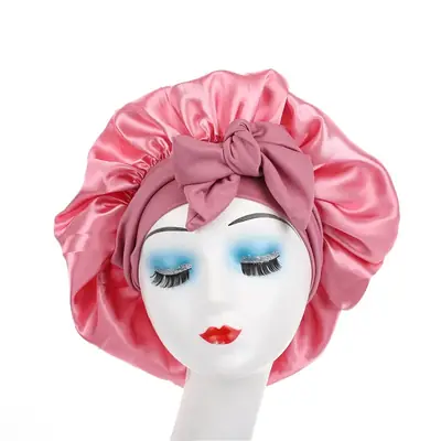 Satin bonnet worn on a head with the tie band tied securely at the back