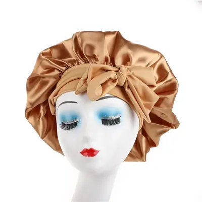 Satin bonnet displayed with a matching satin scrunchie and silk eye mask in a gift set