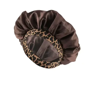 Satin bonnet with leopard print worn during sleep, protecting curly hair