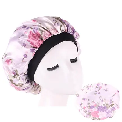 Satin hair bonnet worn on a head, showing the elastic band stretching comfortably