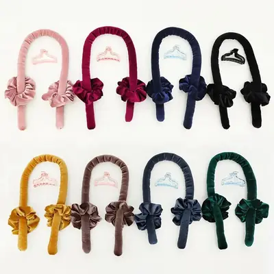 Black satin heatless curler set with claw clip and scrunchies on a white background