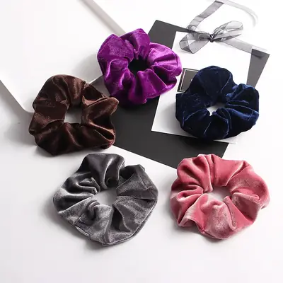 Satin scrunchie wrapped around a ponytail showing the meatball head and smooth fabric