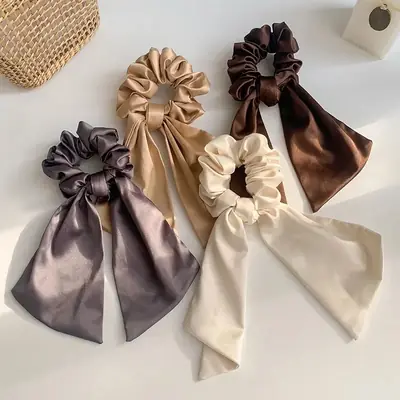Close-up of the hand-stitched seam on a satin scrunchie with plush core