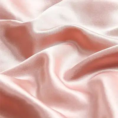 Silk pillowcase with hair wrapped around it, demonstrating low friction