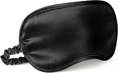 Eye mask worn on a person's face, showing full coverage and elastic strap at the back