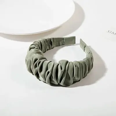 Headband wrapped around a model's head, showing the fit and fabric texture