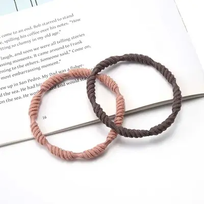 Hair tie wrapped around a ponytail showing the secure, low-profile fit