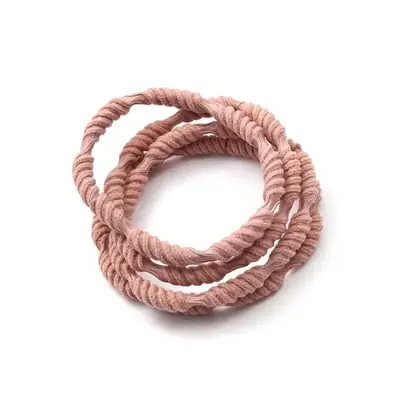 Close-up of a hand-stitched polyester hair tie showing the elastic core and fabric seam