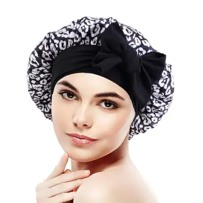 Woman wearing the satin bonnet with floral print, tied securely at the back