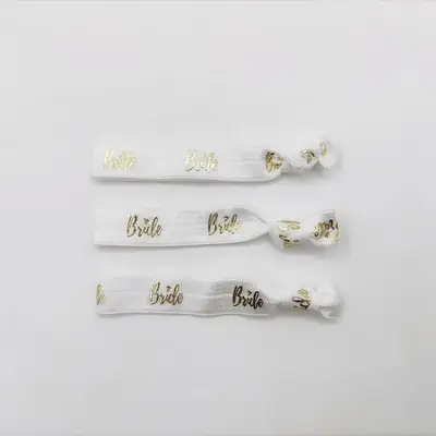 Hair tie with custom logo printed on the band, placed on a white background