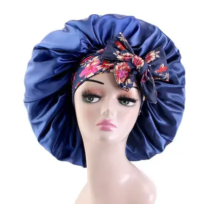 Satin bonnet with floral print on a mannequin head, showing full coverage and fit