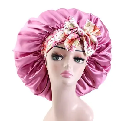 Satin bonnet worn on a head, showing the adjustable bands tied at the back